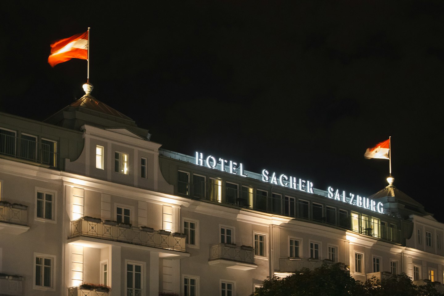 Hotel Sacher Salzburg bei Nacht unter klarem Himmel.
